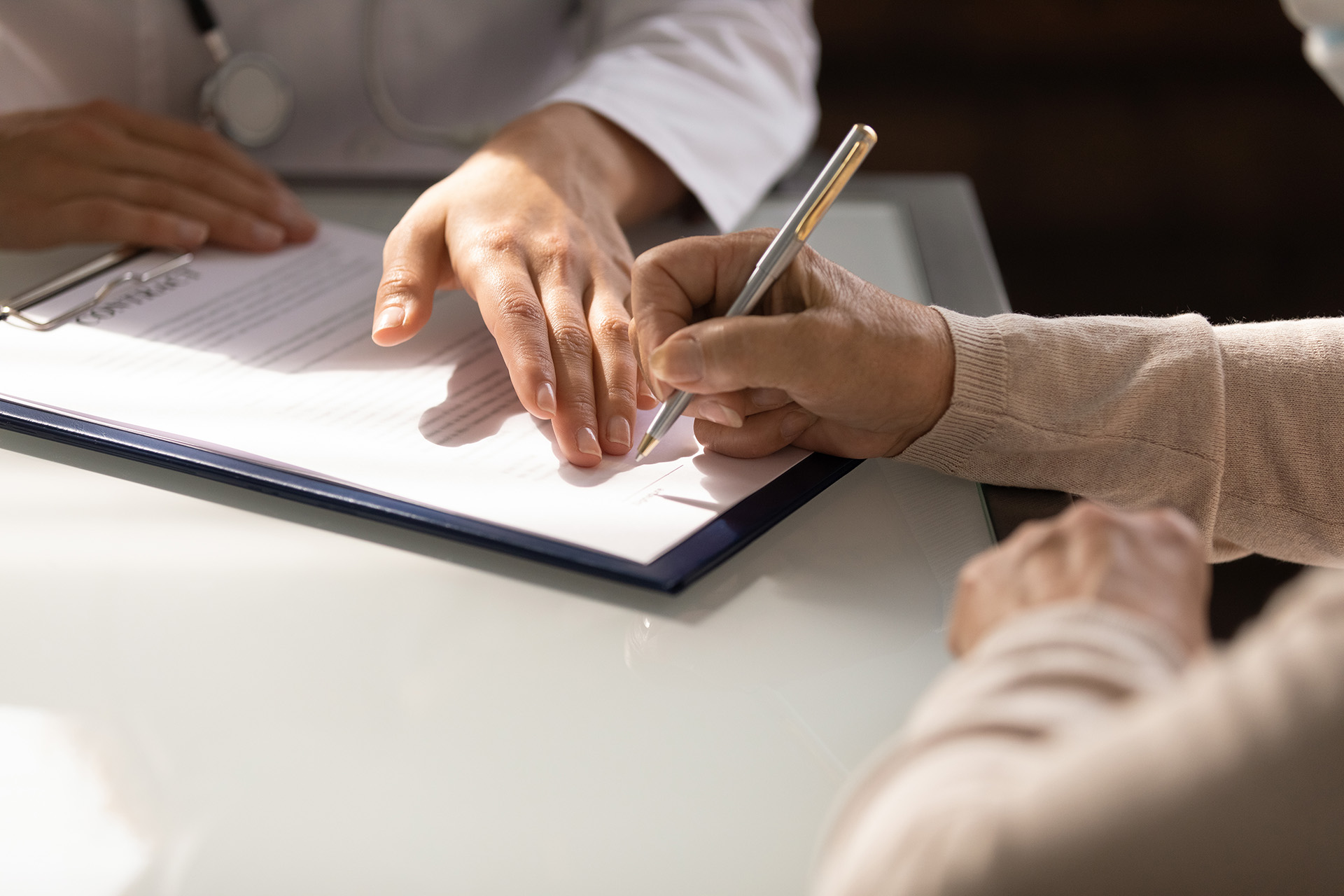 Woman Signing Documents indianapolis personal injury lawyer, Photo of a Woman Signing Documents