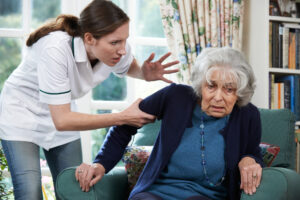 Photo of a A Worker Mistreating a Senior Woman